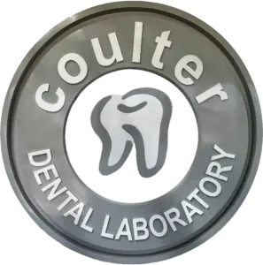 Close-up of a gray circular badge with white text around the edge; 'LABORATORY' is partially visible.