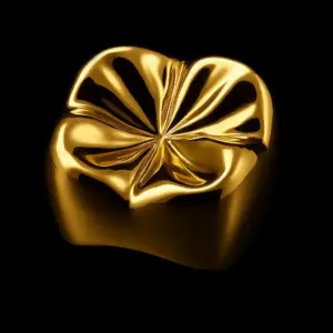 Gold heart-shaped ring with petal-like facets, shiny on a black background (jewelry product)